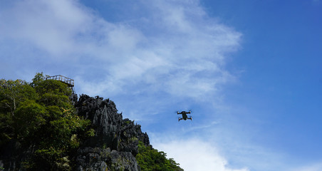 Fototapeta na wymiar Flying drone with blue sky background