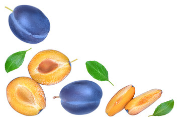 fresh blue plum and half with leaves isolated on white background with copy space for your text. Top view. Flat lay