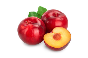 fresh red plum and half with leaves isolated on white background