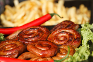 Chili pepper with fried sausages and potatoes