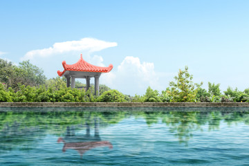 Chinese gazebo building with pond and trees on the park