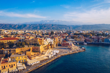 Fototapeta premium Picturesque old port of Chania. Landmarks of Crete island. Greece. Aerial view of the beautiful city of Chania with it's old harbor and the famous lighthouse, Crete, Greece.