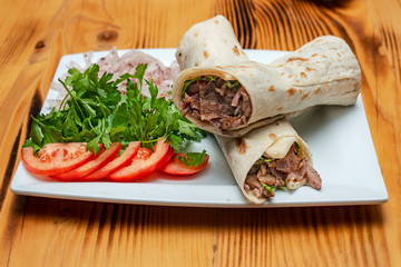 close up of kebab sandwich on wooden background