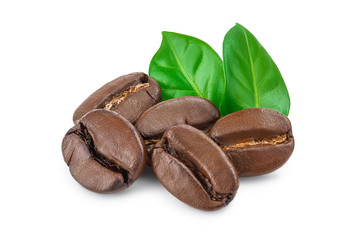 Heap of roasted coffee beans with leaves isolated on white background.