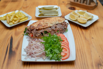 close up of kebab sandwich on wooden background