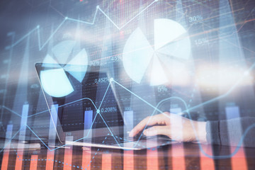 Double exposure of stock market graph with man working on laptop on background. Concept of financial analysis.
