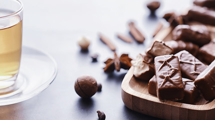 Chocolate bars on a black background in backlight. Chocolate with filling. Sweet sweets for snack and tea.