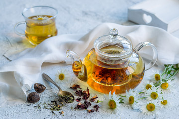 Chamomile tea in a glass teapot