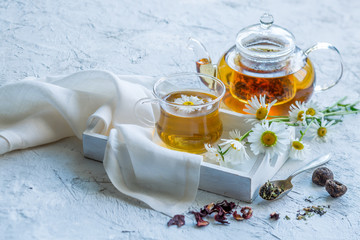 Chamomile tea in a glass teapot