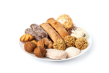 Different types of cookies on white plate isolated on white background.
