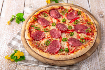 Tasty hot italian pizza Grand Pepperoni with Mozzarella, Tomato Sauce, Pepperoni on old wooden table. Pizzeria menu. Concept poster for Restaurants or pizzerias