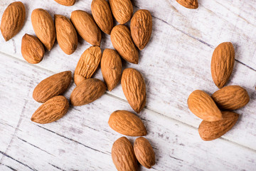 Almonds nut on white wooden table. Almond healthy raw food.