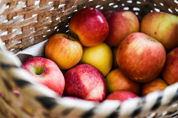 Fresh red apples in wicker basket . Apple healthy veetarian food.