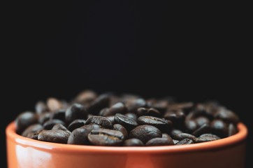 roasted coffee beans in a mug closeup