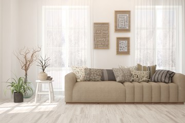 Stylish room in white color with sofa and winter landscape in window. Scandinavian interior design. 3D illustration