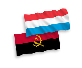 Naklejka premium National vector fabric wave flags of Angola and Luxembourg isolated on white background. 1 to 2 proportion.