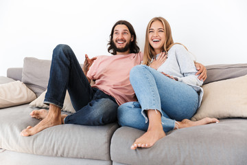 Obraz na płótnie Canvas Couple on sofa watch tv film indoors at home.