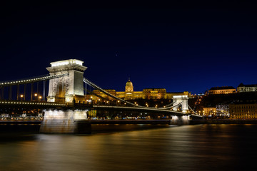 Fototapeta na wymiar Budapest iconic Chain Bridge by night over the Danube River with the Royal Palace and the President's Palace