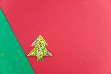 Happy new year and Merry Christmas card minimalistic concept. Handmade paper tree cutting design. Applique paper cutout red and green with copy space for text.