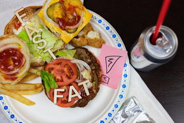 Got fat? letters on a juicy burger Unhealthy eating. Junk food concept.