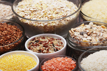 A set of bowls filled with different seeds: buckwheat, rise, corn and oatmeal