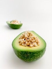 Minimal picture with avocado with the the sprouted grains on white background