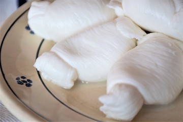 Fresh Mozzarella, traditionally southern Italian cheese made from Italian milk by the pasta filata method in a traditional terracotta plate