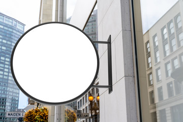 Round white company sign mockup in a beautiful city