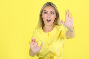 beautiful young woman in a yellow dress on a yellow background