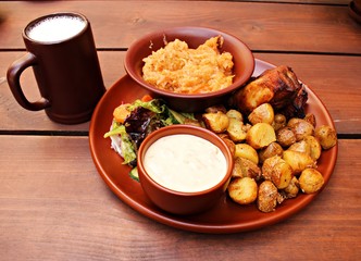 Grilled slice of pork, stewed cabbage, fried potatoes and a glass of village beer