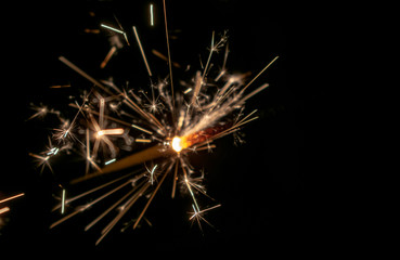 Obraz premium Sparklers burn in the dark, creating a festive mood.