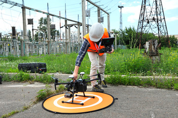 Operator adjusting quadcopter before launching it