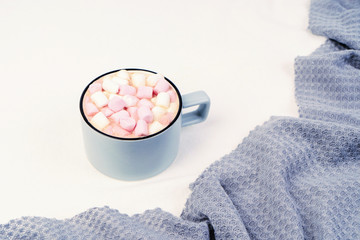 Cup of coffee with pink marshmallow with grayplaid. Copy space.