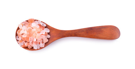 Pink salt in a wooden spoon on a white background