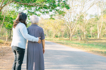 Help and care Asian senior or elderly old lady woman with strong health while walking at park in...