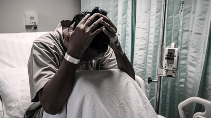 Man with heavy headache in hospital