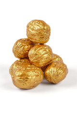 Golden walnuts on a white background