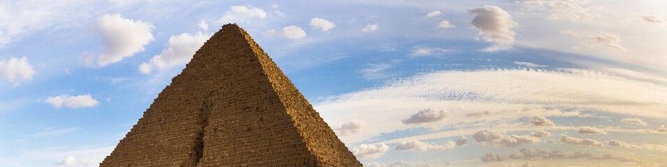 Fototapeta na wymiar Cairo, Giza, Pyramid of Menkaure (Mykerinos, Menkheres), Egypt. Pyramid on the background of the evening cloudy sky.
