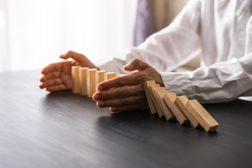 Stopping the domino effect concept for business solution, strategy and successful intervention