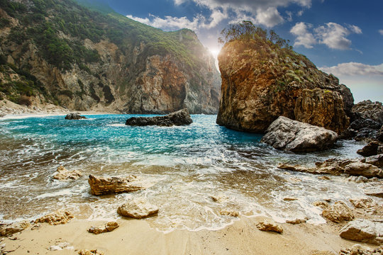 Scenic Greece landscape. Seascape of Ionian Sea. Greece. Gyali beach with colorful sky during sunset. Corfu island, Greece, Europe. Adventures and exotic travel concept. Wonderful summer view.