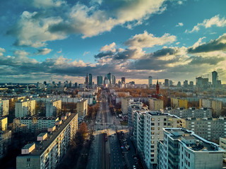 Fototapeta na wymiar Beautiful panoramic aerial drone view to the Сenter of modern Warsaw city with silhouettes of skyscrapers in in the rays of the setting winter January sun - amazing sunset, Poland