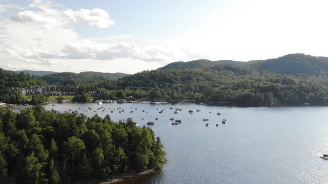 Mont Tremblant, Quebec. Marina and forested lake parallax zoom out aerial 4K Mavic 2 Zoom