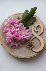 pink flowers on March 8 on a wooden background