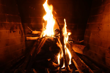 Cosy fireplace with reddish fire at winter time