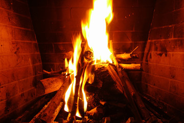 Cosy fireplace with reddish fire at winter time