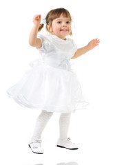 Fototapeta na wymiar Happy little girl posing in white dress