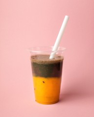 Fresh smoothie of mango and chia seeds on pink colorful background