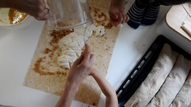 Mother making strudel with her children