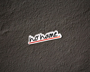 No name sign sticker on textured gray wall