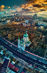 Beautiful panoramic aerial drone view to the Сenter of modern Warsaw city with silhouettes of skyscrapers and Church Karol Boromeusz (at the Powazki Cemetery) in amazing winter January sunset, Poland - obrazy, fototapety, plakaty